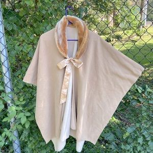 Fleece cape with faux fur collar. One size fits most.